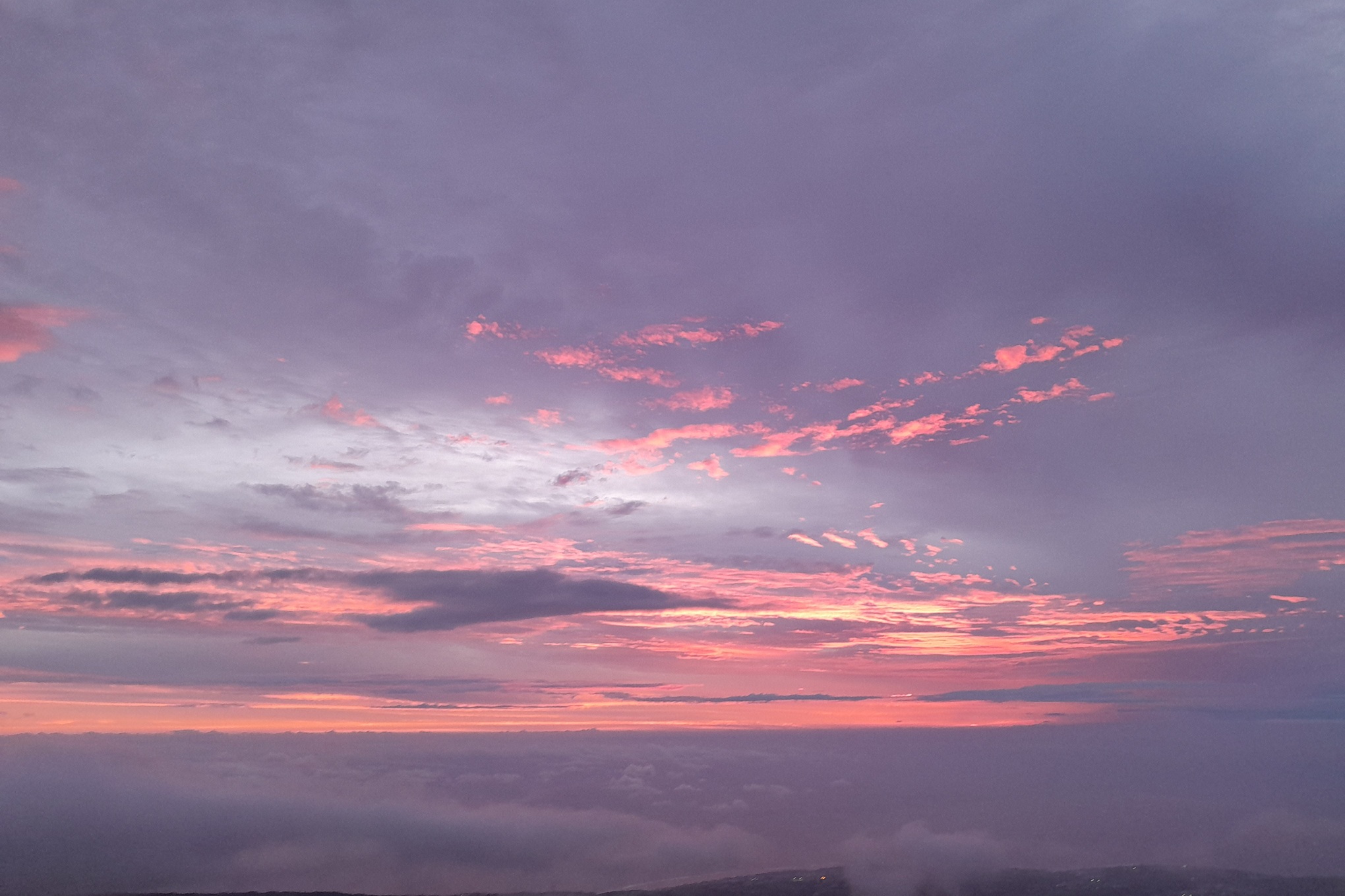 dark sunset in La Réunion, with thick clouds and golden filtered light at the horizon