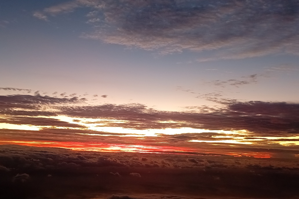 intense sunset in La Réunion, with a deep red sky and dark clouds on the horizon